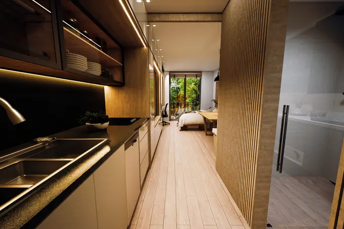 Cocina lineal y balcón al fondo del apartaestudio